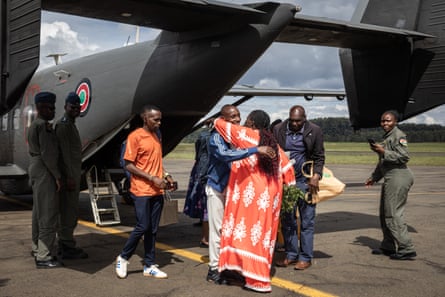 Lydia Sawe greets her husband, Sabastian, off the military plane.