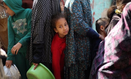Palestinians queue for food at a charity kitchen in Rafah on 5 February.