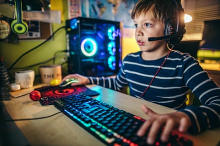 Young boy playing games on a computer at home