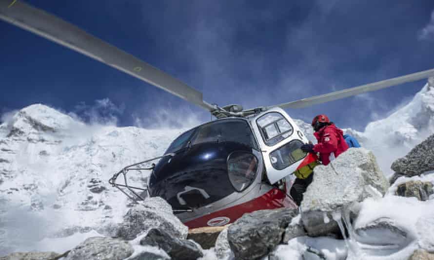 A rescue helicopter is shown at the Mount Everest south base camp in Nepal. Rescue teams, helped by clear weather, used helicopters to airlift scores of people stranded at higher altitudes, two at a time. 