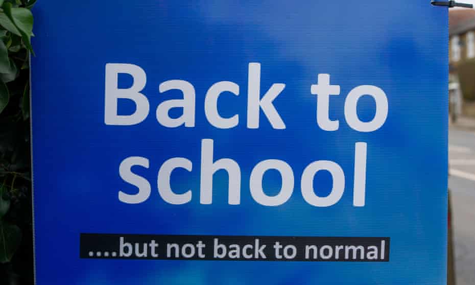 A ‘back to school … but not back to normal’ sign is seen outside Eton Wick school in Windsor