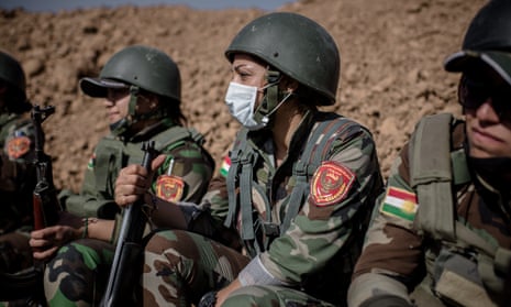 A female Syrian Kurdish Peshmerga unit at a forward fighting position.