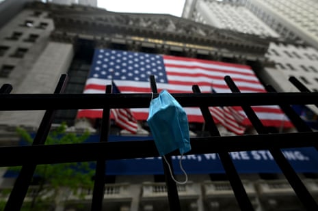 A face mask is seen in front of the New York Stock Exchange.