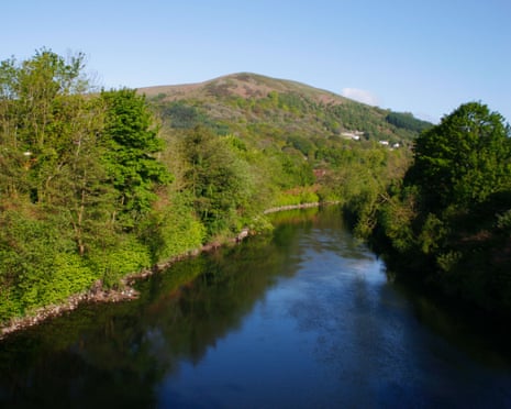 Narrow stretch of river with hill in background
