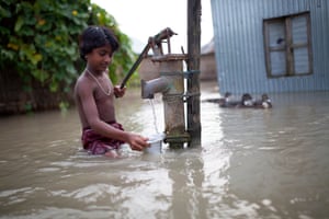 A young boy collects drinking water