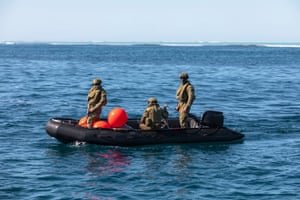 Australian Clearance Diving Team One prepare their diving equipment on a Zodiac inflatable boat near Elizabeth Reef.