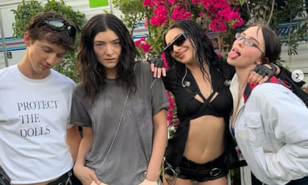 Troye Sivan (left) wearing a 'Protect the Dolls' T-shirt while posing alongside Lorde, Charli xcx and Billie Eilish