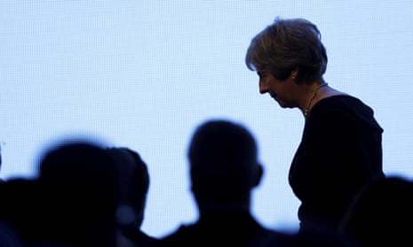 Theresa May leaves the stage after giving a speech at the United Jewish Israel Appeal charity dinner in London