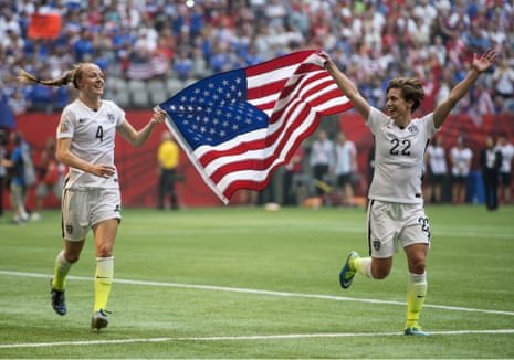 The flags are out, as USA teammates Becky Sauerbrunn, left, and Meghan Klingenberg celebrate becoming world champions.