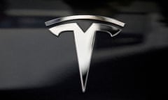 A silver logo on the bonnet of a black Tesla in Los Angeles, California