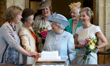 The Countess of Wessex (right) and Princess Anne (second left) watch as the Queen cuts a cake at the WI’s centenary annual meeting.