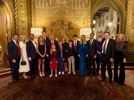 crowd of people pose for photo in gold-lined room