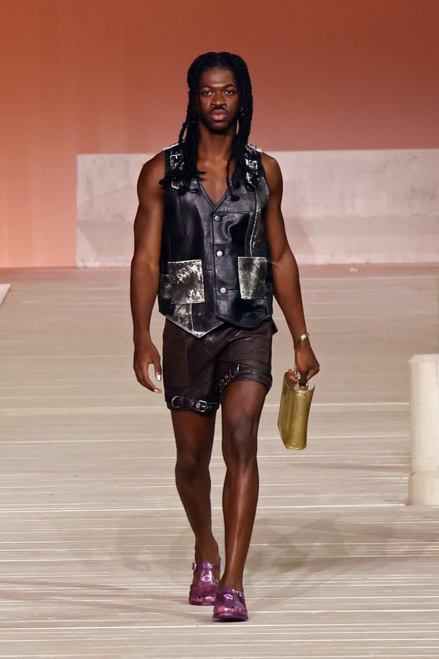 Rapper Lil Nas X wearing a big leather waistcoat and shorts on the Coach runway