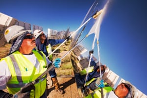 Workers washing the heliostats to maximise reflective power at the Ivanpah solar thermal power plant