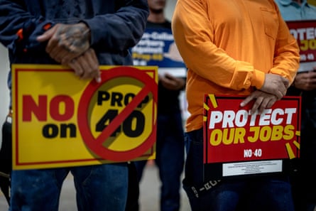 two signs that say âÂÂNo on Prop 40â and âÂÂProtect Our JobsâÂÂ