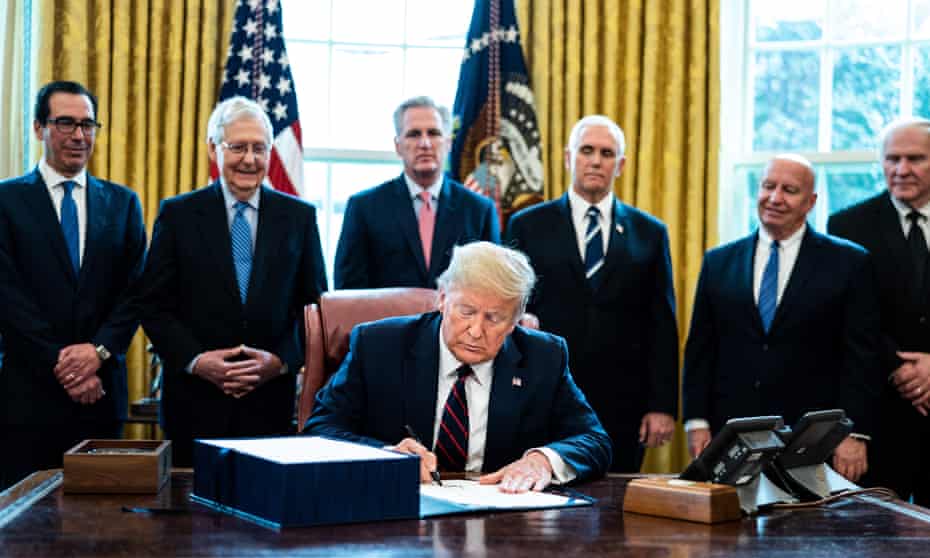 Trump participates in a signing ceremony for the coronavirus stimulus package in the Oval Office at the White House in Washington DC, on 27 March. 