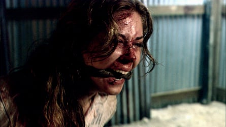 A bloody woman, gagged and bound, appears to scream.