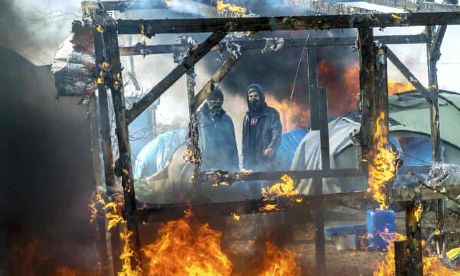 A makeshift shelter burns in the ‘Jungle’ migrant camp in Calais
