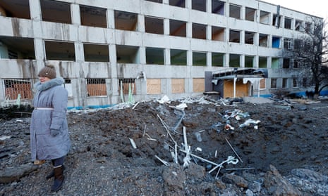 A woman stands at the site of a missile strike that occurred during the night in Kramatorsk, Ukraine.