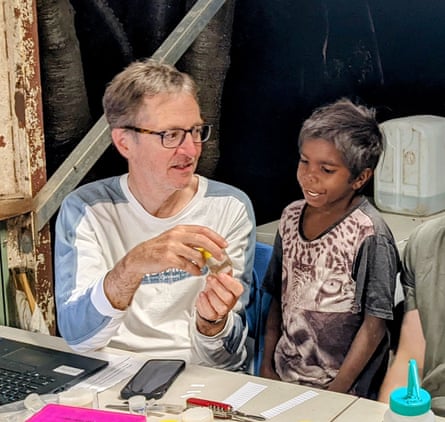 Mark Harvey in field lab showing child from Wilinggin Country discoveries made during West Kimberley field trip.