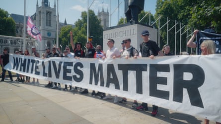 Far-right activists holding a 'White lives matter' banner