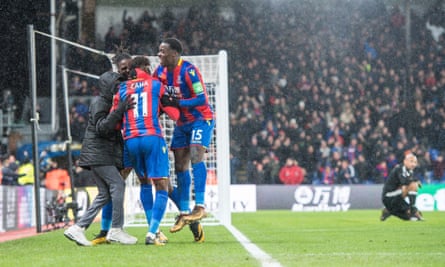 Wilfried Zaha, Jeffrey Schlupp and Bakary Sako celebrate with a ball boy after Crystal Palace’s second goal against Watford.