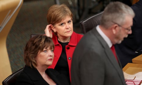 Nicola Sturgeon listens as MSP Mike Russell speaks during a Scottish parliament debate