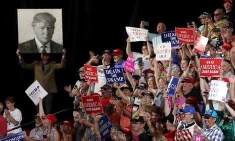 Donald Trump supporters hold signs during a campaign rally at Four Seasons Arena on Thursday in Great Falls, Montana.