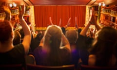 Audience clapping in theatre.
