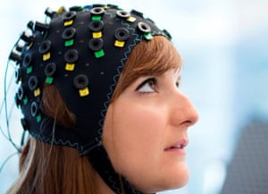 Shown here on a model, the cap uses infrared light to spot variations in blood flow in different regions of the brain. A computer learns to distinguish the blood flow patterns for “yes” and “no” for each patient.