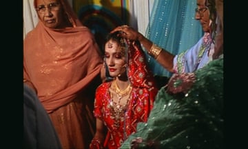 Two older women with a younger woman in formal dress in a scene from Moosa Lane