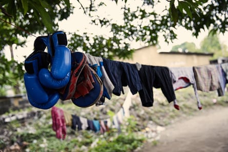 Boxing gloves on a washing line outside boxer Miki Ndaya’s house