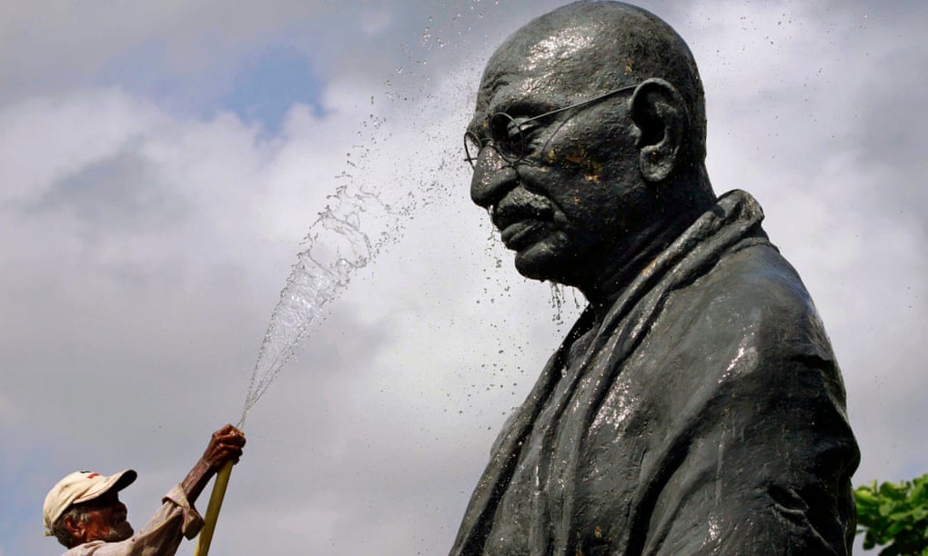A worker cleans the statue of the Mahatma Gandhi in Bhubaneswar, Odisha.