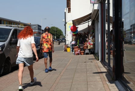 People walking down a street on a hot day