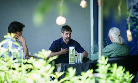 Stephen Guilbeau sits at a table with Justin Trudeau and Jane Goodall
