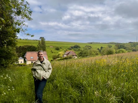a woman stands in a field