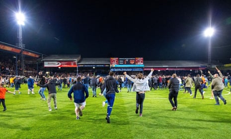 Fans storm the pitch after Luton Town’s second-leg comeback against Sunderland secured their place in the playoff final at Wembley