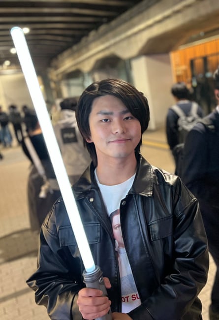 Gohta Hashimoto, a university student, brandishes his lightsaber at a rally in support of Japan’s peace constitution held in Shinjuku, Tokyo, on 16 April.