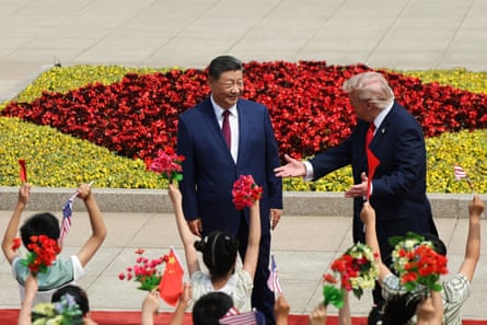 children wave flowers at two men in suits