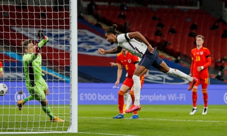 Dominic Calvert-Lewin powers a header past Wales’s Wayne Hennessey for a goal on his England debut