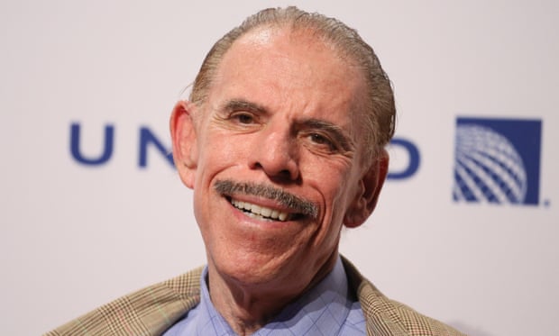 A portrait of Peter Max, an elderly man with gray hair and a mustache, at a gala in 2014.