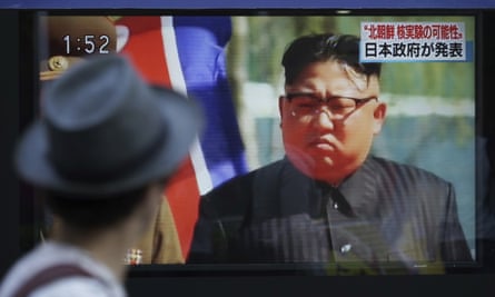 Kim Jong-un on an oudoor video screen showing a Japanese news broadcast.