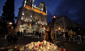Candles are lit outside the Notre-Dame de l’Assomption Basilica in Nice on 30 October in memory of the three people murdered there the day before.
