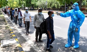 People in need of food assistance get their temperatures checked in New Delhi on 30 May 2020 as India reported as a record daily rise in Covid-19 infections.