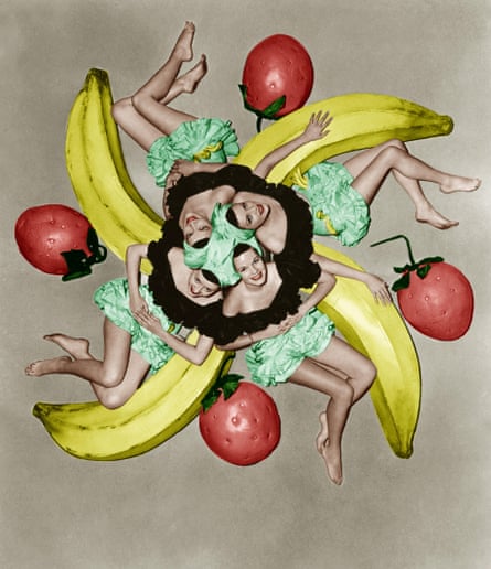 Aerial shot of four dancers in skimpy fruit-themed outfits, surrounded by giant fake bananas and strawberries
