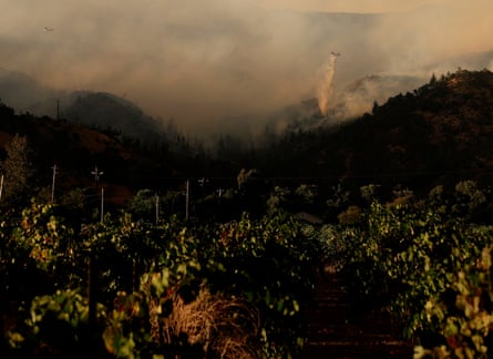 Helicopter drops water on to the wildfire