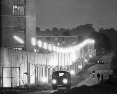 A police van drives by the lighted barbed wire fence of the Stuttgart-Stammheim maximum-security prison 1975.