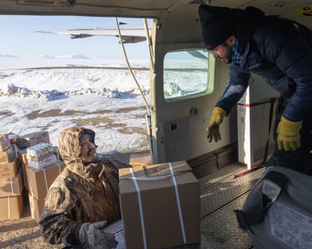 Newtok village agent Jonah Ayuluk chats with pilot Miguel Paez as they unload freight from a Cessna Caravan. Newtok, a small village of about 350 people, is one of many Alaska Native villages that rely on air transport for essential services like groceries.