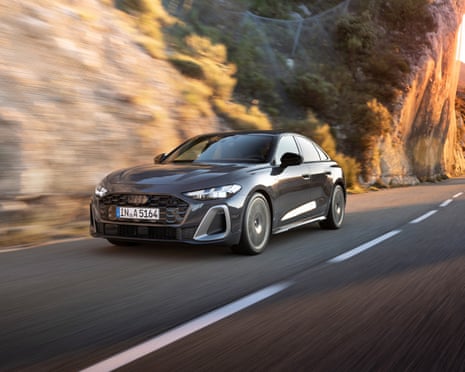 An Audi A5 saloon drives along a coastal road.