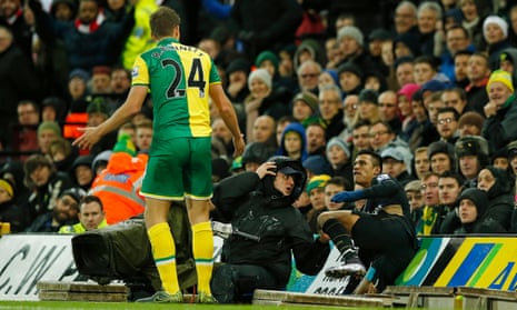 Arsenal’s Alexis Sánchez stares at the Norwich defender Ryan Bennett, left, after ending up in the TV camera pit during the 1-1 draw at Carrow Road.